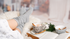 Relaxing with warm socks on on sofa with book and hot chocolate