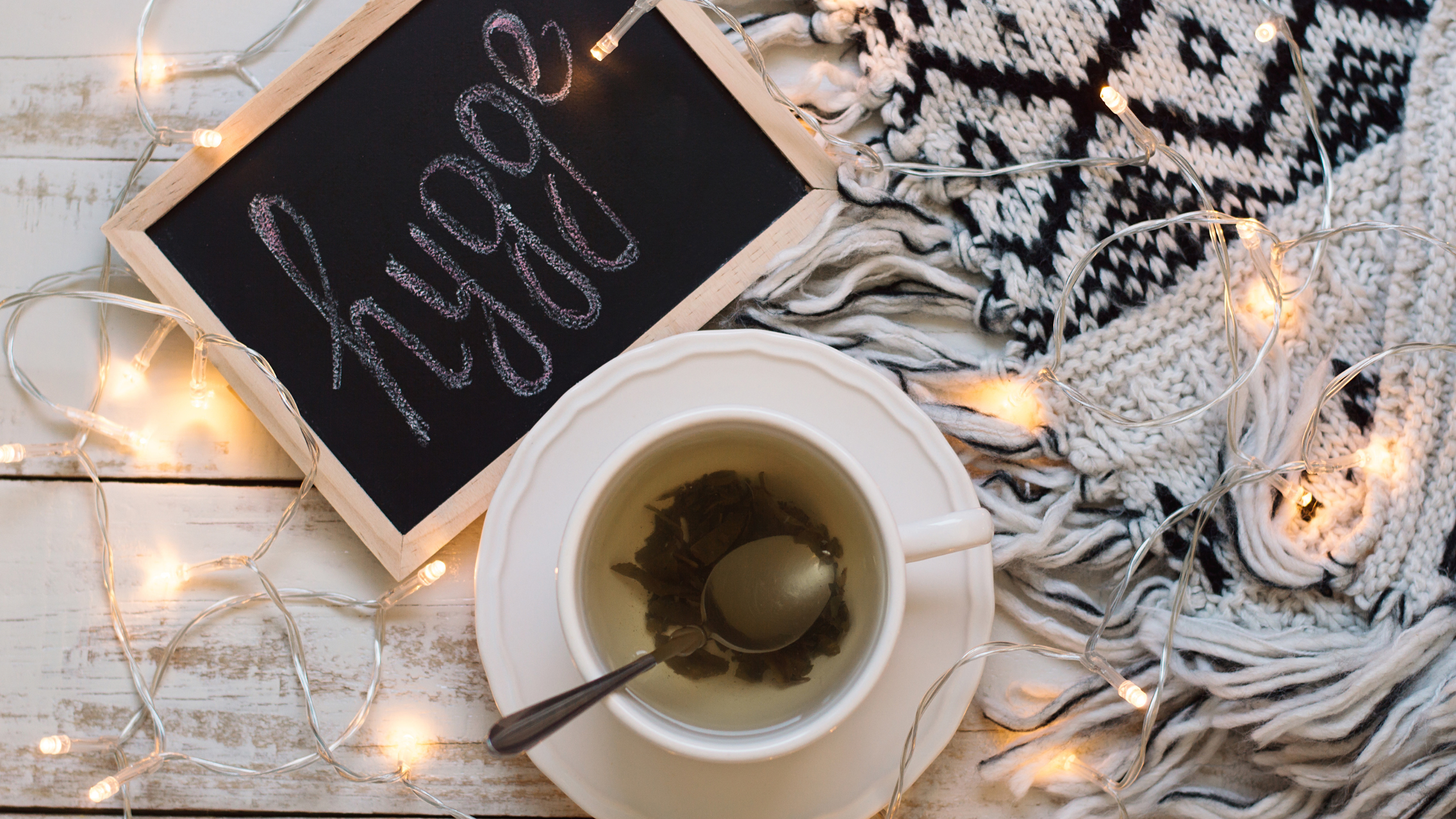 blackboard with 'hygge' written upon it next to herbal tea